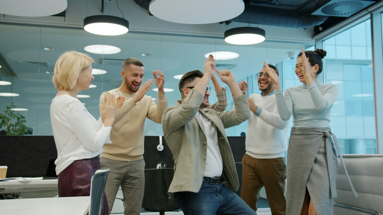 Diverse group of HR colleagues celebrating success in office